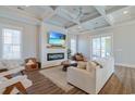 Bright living room features a coffered ceiling, fireplace, and sliding doors to the outdoor space at 848 Crystal Water Way, Myrtle Beach, SC 29579
