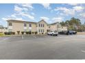 Condominium exterior featuring well-maintained landscaping and ample parking at 8538 Hopkins Circle # E, Surfside Beach, SC 29575