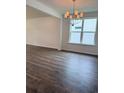 Open dining area with hardwood floors, large window, and elegant chandelier at 8639 Farrier Dr., Myrtle Beach, SC 29588