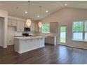 Bright, open kitchen with gray cabinets, quartz countertops, and stainless steel appliances at 8639 Farrier Dr., Myrtle Beach, SC 29588