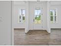 Bright foyer showcasing the front door and hardwood floors at 885 Bear Lake Dr., Longs, SC 29568