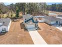 Aerial view of the tan two-story home with long driveway and landscaping at 120 Carolina Lakes Blvd., Myrtle Beach, SC 29588