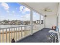 Enjoy water views from the covered porch with white railings and a ceiling fan at 1537 Lanterns Rest Rd. # 202, Myrtle Beach, SC 29579