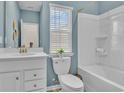 Bright bathroom featuring white vanity, toilet, and shower/tub combination with neutral wall color at 1604 Seachase Way, North Myrtle Beach, SC 29582