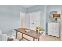 Stylish home office space with modern desk, decorative lamp, and a neutral color scheme at 1604 Seachase Way, North Myrtle Beach, SC 29582