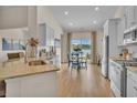 Modern kitchen with stainless steel appliances and granite countertops, flowing into a bright dining area with lake views at 1609 Seachase Way, North Myrtle Beach, SC 29582