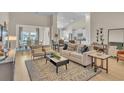 Bright living room featuring stylish furniture, modern decor, and an open layout, flowing into the dining area at 1609 Seachase Way, North Myrtle Beach, SC 29582