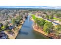 Scenic aerial view of the house overlooking a tranquil golf course, trees, and a wide waterway at 1616 Hawthorn Dr., Pawleys Island, SC 29585