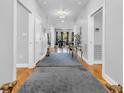 Inviting hallway featuring hardwood floors, elegant decor, and a glimpse into the living spaces at 1616 Hawthorn Dr., Pawleys Island, SC 29585