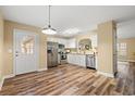 Modern kitchen featuring stainless steel appliances, granite countertops, white cabinets, and modern lighting at 177 Reef Run Rd., Pawleys Island, SC 29585