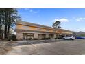 Low-angle exterior showcases a two-story townhome featuring a brick facade and covered parking at 1851 Fairway Ridge # 7C, Surfside Beach, SC 29575