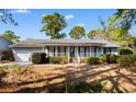 Inviting single-story home with a cozy front porch and manicured landscaping at 228 Lander Dr., Conway, SC 29526