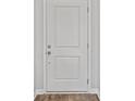 A closer view of the front door, a simple and minimalist white panel door that lets you in at 272 Warner Crossing Way, Loris, SC 29569