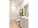 Clean bathroom with a shower-tub combo, a white vanity, and neutral tile flooring at 280 Warner Crossing Way, Loris, SC 29569