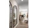 Bright entryway featuring hardwood floors, decorative mirrors, and a view into the dining area at 280 Warner Crossing Way, Loris, SC 29569