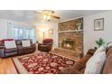 Cozy living room featuring a brick fireplace, plush seating, and a vibrant patterned rug at 317 14Th Ave. N, Surfside Beach, SC 29575