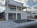 New construction coastal home with pool and spacious porch, exterior view at 318 Vista Dr., Murrells Inlet, SC 29576