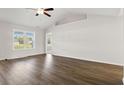 Spacious living room with vaulted ceiling, ceiling fan, hardwood floors, and abundant natural light at 375 West Dogwood Rd., Loris, SC 29569