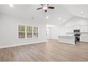 Bright, open-concept living space with hardwood floors, a vaulted ceiling, and large windows at 383 West Dogwood Rd., Loris, SC 29569