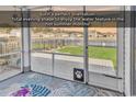 A screened porch offers an outdoor view of a serene water feature and lush greenery at 417 Accord St., Myrtle Beach, SC 29588