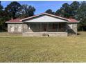 Charming brick home featuring a covered front porch with metal railing and a red metal roof at 51 Cleburn St., Georgetown, SC 29440