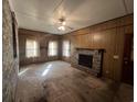 Cozy living room featuring a brick fireplace, wood paneled walls, and large windows at 51 Cleburn St., Georgetown, SC 29440