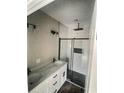 Modern bathroom showcasing a double sink vanity and a luxurious glass-enclosed shower with elegant black accents at 5374 Hampton Rd., Conway, SC 29527