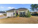 A beautiful front exterior shot with nice landscaping and a well manicured lawn at 685 Tidal Point Ln., Myrtle Beach, SC 29579