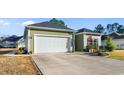 A full shot shows the house and garage and the beautiful lawn it sits on at 685 Tidal Point Ln., Myrtle Beach, SC 29579