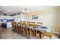 Open-concept dining area with seating for twelve and modern chandelier at 817 S Ocean Blvd. # 105, North Myrtle Beach, SC 29582