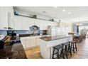 Spacious kitchen with granite countertops, breakfast bar, and white cabinetry at 817 S Ocean Blvd. # 105, North Myrtle Beach, SC 29582