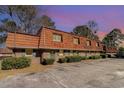 Brick exterior with unique wood roof, green doors, and lots of plants in front of this multi Gathering townhome at 1025 Carolina Rd. # Cc2, Conway, SC 29526