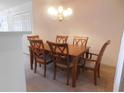 Dining area includes a wood table, six chairs, and a chandelier at 1027 Pinwheel Loop # 3103, Myrtle Beach, SC 29577