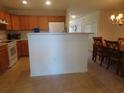 Eat-in kitchen with wood cabinets, white appliances, a breakfast bar, and a dining area at 1027 Pinwheel Loop # 3103, Myrtle Beach, SC 29577