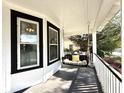 Cozy front porch featuring a swing, perfect for enjoying the outdoors at 103 South Rosemary Ave., Andrews, SC 29510
