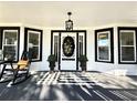 Inviting front porch with black and white accents, rocking chair, and stylish decor at 103 South Rosemary Ave., Andrews, SC 29510