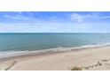 Expansive ocean and beach view with blue skies and a few people in the distance at 1105 S Ocean Blvd. # 1210, Myrtle Beach, SC 29577