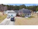 Aerial view of home with two car garage, well manicured yard and long driveway with room to park multiple vehicles at 113 Cat Tail Bay Dr., Conway, SC 29527