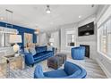 Chic living room featuring plush blue seating, a marble fireplace, and an open layout perfect for entertaining at 125 Harbor Oaks Dr., Myrtle Beach, SC 29588