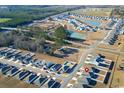 An aerial view shows a new development with a pond, neat streets, and a cul-de-sac in a serene environment at 127 Clover Walk Dr., Conway, SC 29526
