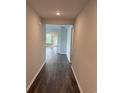 Hallway view showing luxury vinyl plank flooring, fresh paint, and an open floor plan at 183 Glengrove Lane, Murrells Inlet, SC 29576
