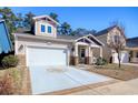 View of the home's front exterior, showcasing its driveway and partial lawn at 1878 Heritage Loop, Myrtle Beach, SC 29577