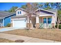 Angle view of house featuring the garage, front door and front lawn at 1878 Heritage Loop, Myrtle Beach, SC 29577