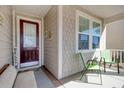 Inviting front porch with seating area and decorative front door at 1878 Heritage Loop, Myrtle Beach, SC 29577
