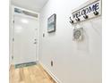 Entryway with wood flooring and a welcome sign hanging on the wall at 210 Double Eagle Dr. # G1, Myrtle Beach, SC 29575