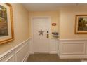 Condo entryway with white door, 'Welcome' sign, and beach decor art at 2241 Waterview Dr. # 227, North Myrtle Beach, SC 29582