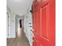 Bright entryway with a red front door, wood-look floors, and neutral paint throughout at 2970 Old Bryan Dr. # A5, Myrtle Beach, SC 29577