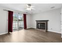Cozy living room featuring a brick fireplace, ceiling fan, and sliding door to the patio at 2970 Old Bryan Dr. # A5, Myrtle Beach, SC 29577