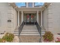 Elegant entryway with double doors, decorative wreaths, and stone steps at 3100 Lahinch Dr., Myrtle Beach, SC 29579