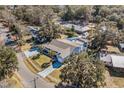 Aerial view of the property showcasing a spacious lot, manicured lawn, in-ground pool, and mature trees at 321 Jay St., Murrells Inlet, SC 29576